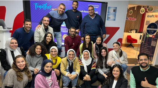 A group of people posing for a photo in an office.