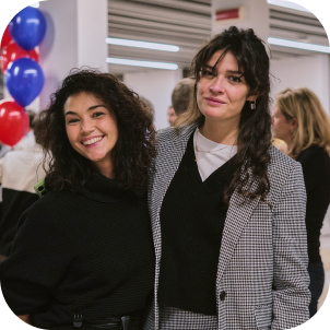 Two women posing for a photo together and smiling.