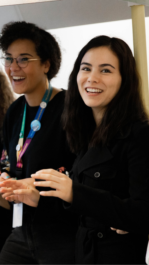 A group of women smiling and laughing.