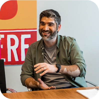 Man smiling and sitting at a table