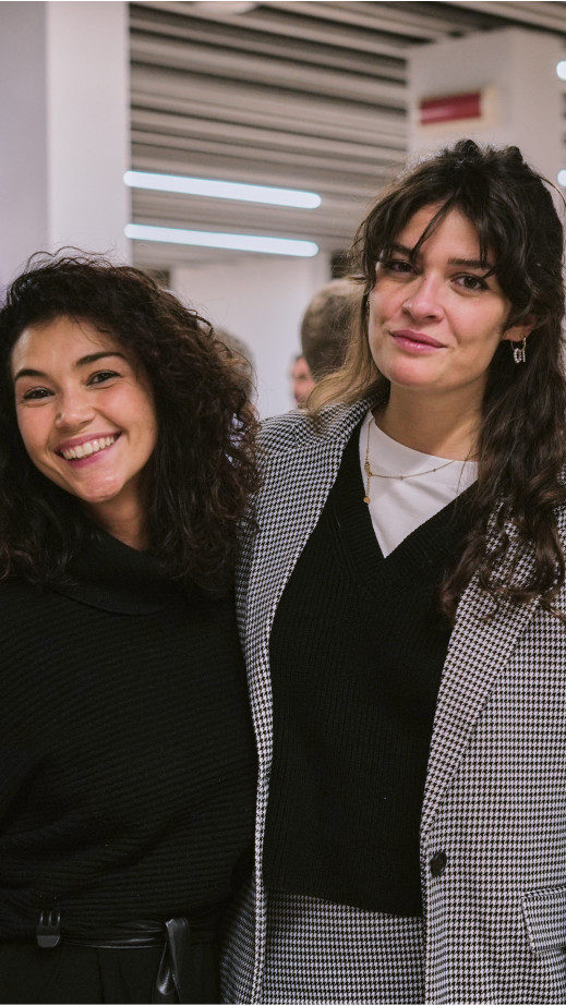 Two women smiling and posing for a photo.